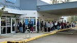 Person holding a REAL ID-compliant driver's license at a DMV office