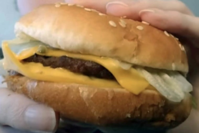 Close-up of a fast food burger with fresh toppings, representing the focus keyword burgers