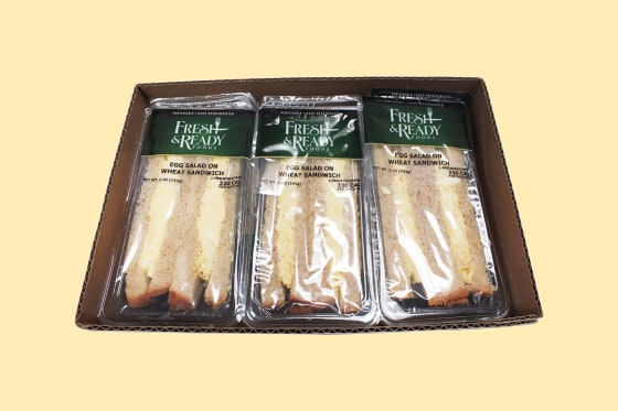 A refrigerated case of ready-to-eat foods with a recall notice, related to the listeria outbreak in California