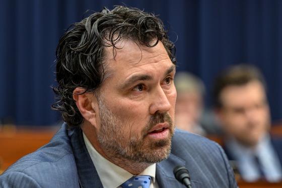 A worried veteran reviewing financial documents, illustrating VA overpayment challenges