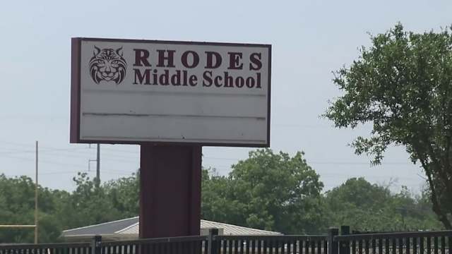 School entrance with police presence, related to Ashley Pardo case