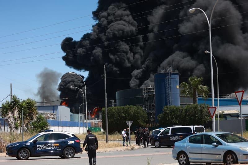 Seville skyline under smoke after a chemical plant explosion