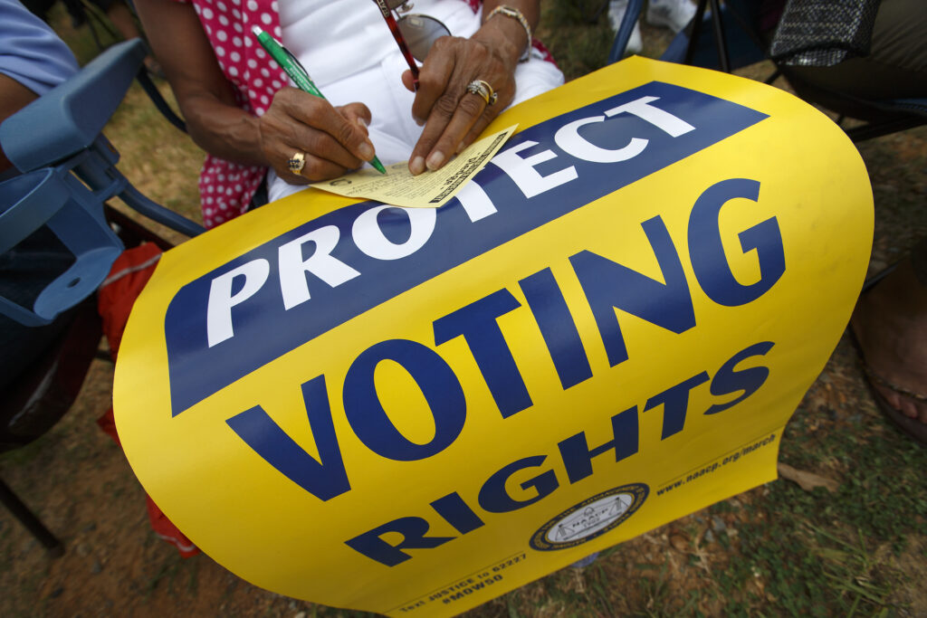 Demonstrators supporting voting rights outside a courthouse following the 8th Circuit Voting Rights Act ruling.