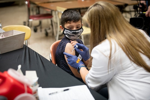Child receiving immunizations during a routine health checkup
