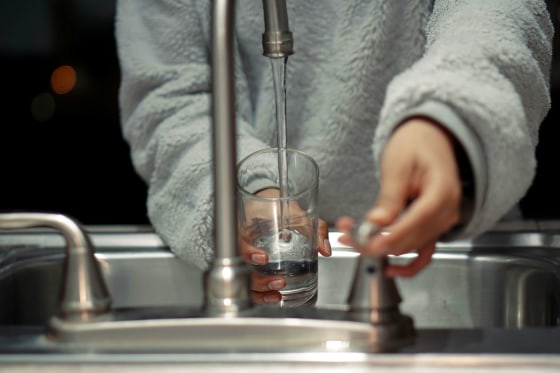 A river reflecting industrial discharge, highlighting the risk of PFAS contamination in water supplies