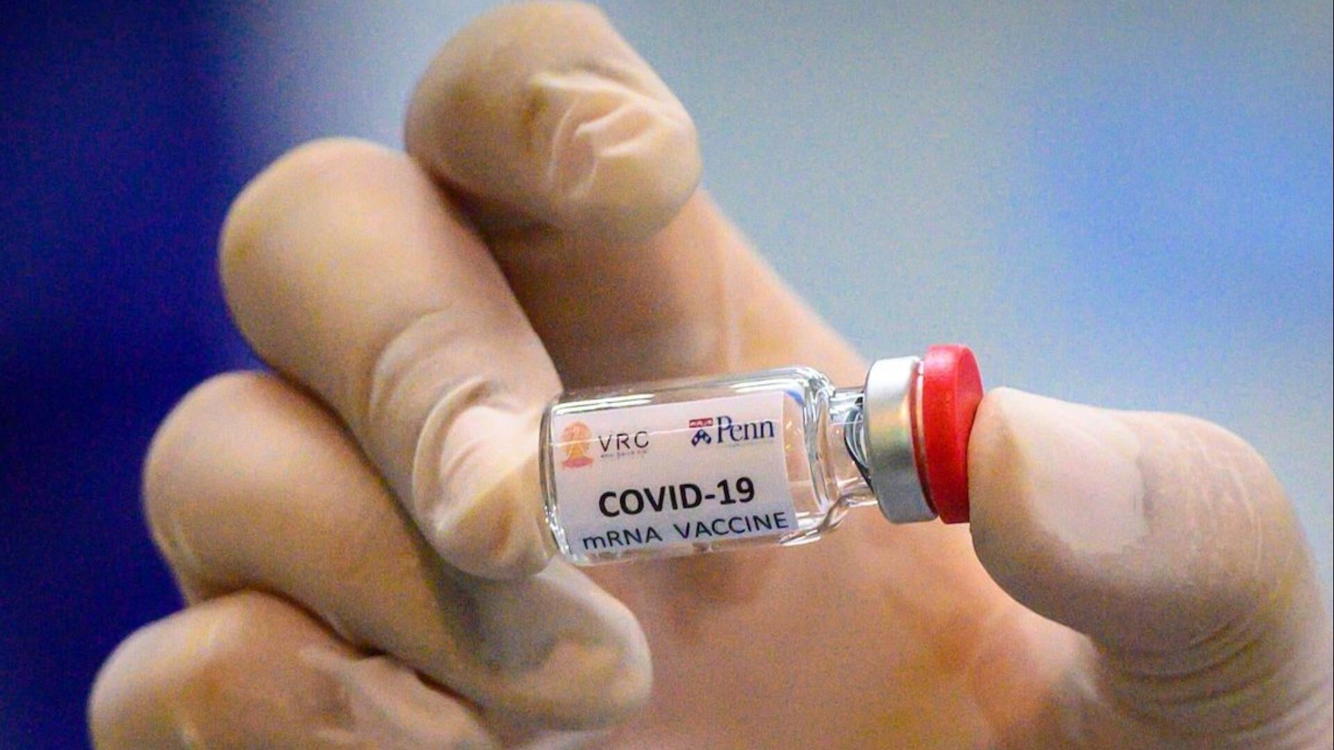 A healthcare worker administering a COVID-19 vaccine, representing the latest covid response in 2025